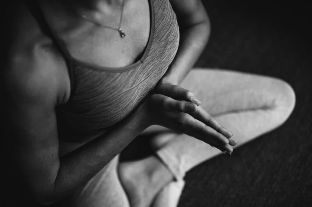 Person beim Meditieren im Yoga-Sitz, Nahaufnahme der Hände, Yoga-Programm im Hotel Pehab.